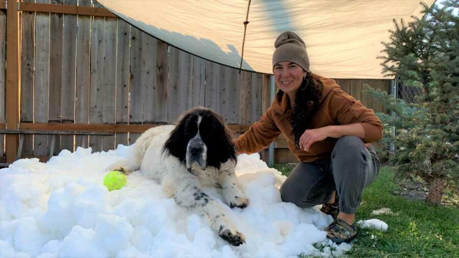 Marianna poses with Maggie atop her snow pile.